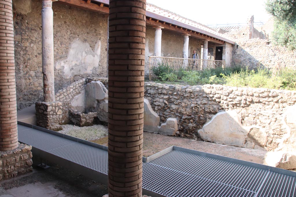 I.9.14 Pompeii. October 2022.
Room 2, looking north-west across lower garden area with remains of painted wall. Photo courtesy of Klaus Heese.