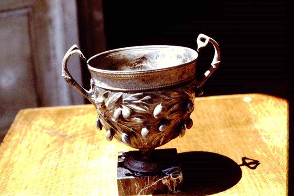I.10.4 Pompeii. 1971. Silver cup decorated with olives.  Photo by Stanley A. Jashemski.
Source: The Wilhelmina and Stanley A. Jashemski archive in the University of Maryland Library, Special Collections (See collection page) and made available under the Creative Commons Attribution-Non Commercial License v.4. See Licence and use details. J71f0269
