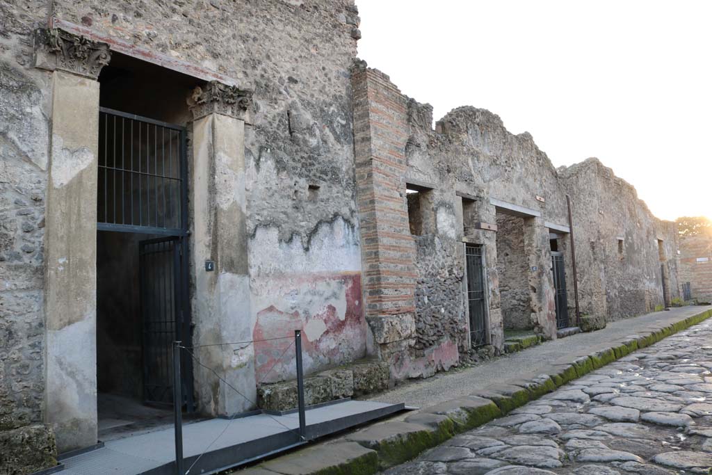 1.10.4 Pompeii, on left. December 2018.  
Looking south-west along north side of insula, towards doorways between I.10.4 and I.10.8. Photo courtesy of Aude Durand.

