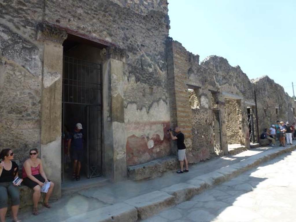 1.10.4 Pompeii. June 2012. Looking south-west along north side of insula, with entrance doorway on the left. Photo courtesy of Michael Binns.

