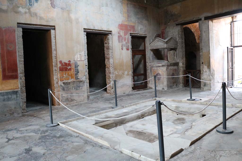 I.10.4 Pompeii. December 2018.  
Looking towards north-west corner of atrium, the lararium and doorway to room 2. 
Photo courtesy of Aude Durand.
