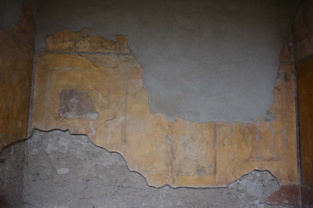 I.10.4 Pompeii. October 2017. Alcove 23, looking towards south wall.
Foto Annette Haug, ERC Grant 681269 DÉCOR.
Alcove 23, south wall, –
painted masks, on left, with possibly Bacchus sitting on a chair with robe covering his legs in central panel, and painted table, on right.
See Kuivalainen, I., 2021. The Portrayal of Pompeian Bacchus. Commentationes Humanarum Litterarum 140. Helsinki: Finnish Society of Sciences and Letters, (p.104, B17).

