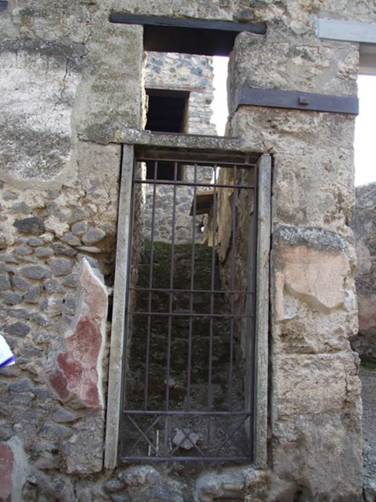 I.10.5 Pompeii. December 2007. Stairs to upper floor. 
11 masonry steps leading to a small independent apartment.
Red painted plaster on exterior wall on east side of doorway.
