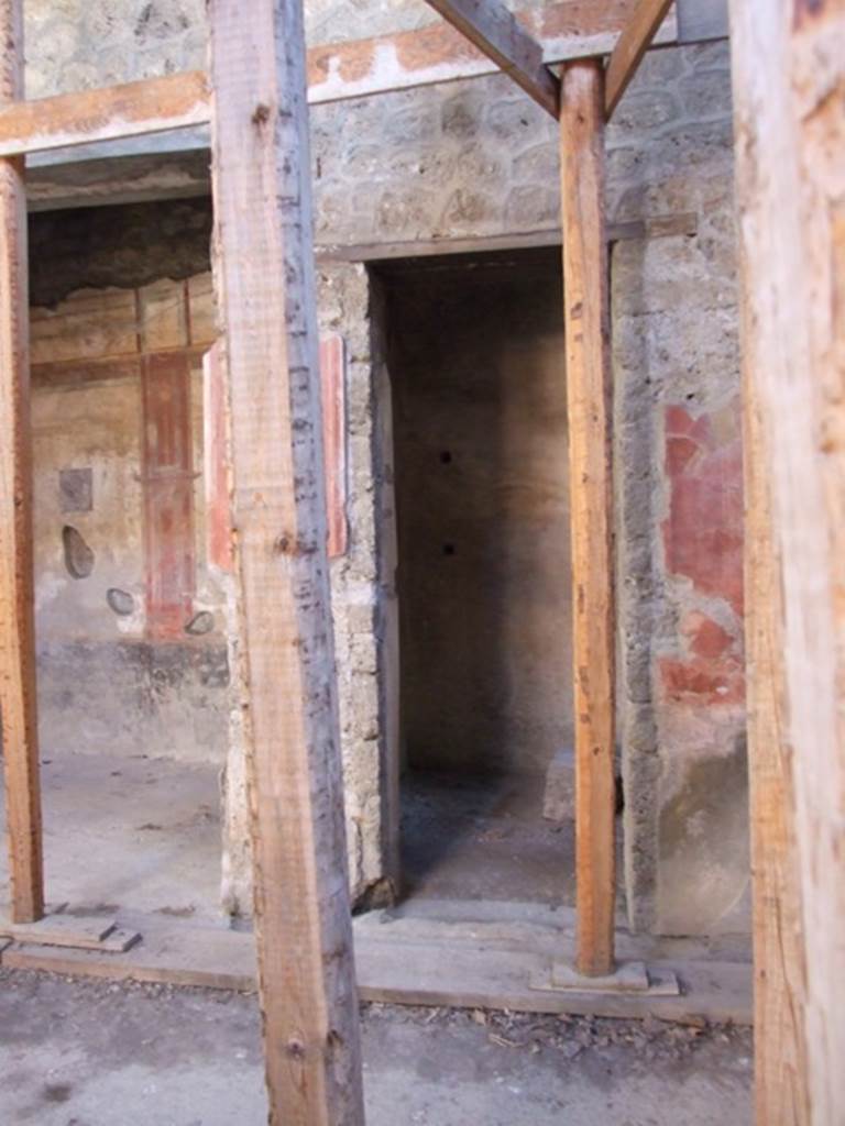 I.10.11 Pompeii. March 2009. Room 5, doorway into room with traces of shelving supports.