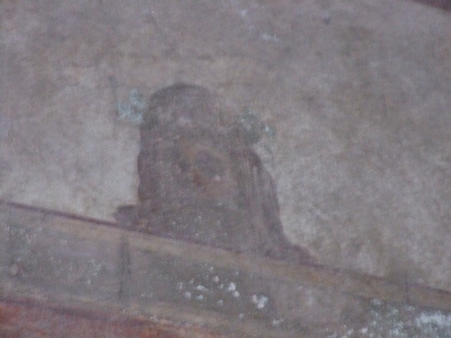 I.10.11 Pompeii.  March 2009.  Room 12.  Cubiculum.  North wall.  Upper part.  Painting of mask.