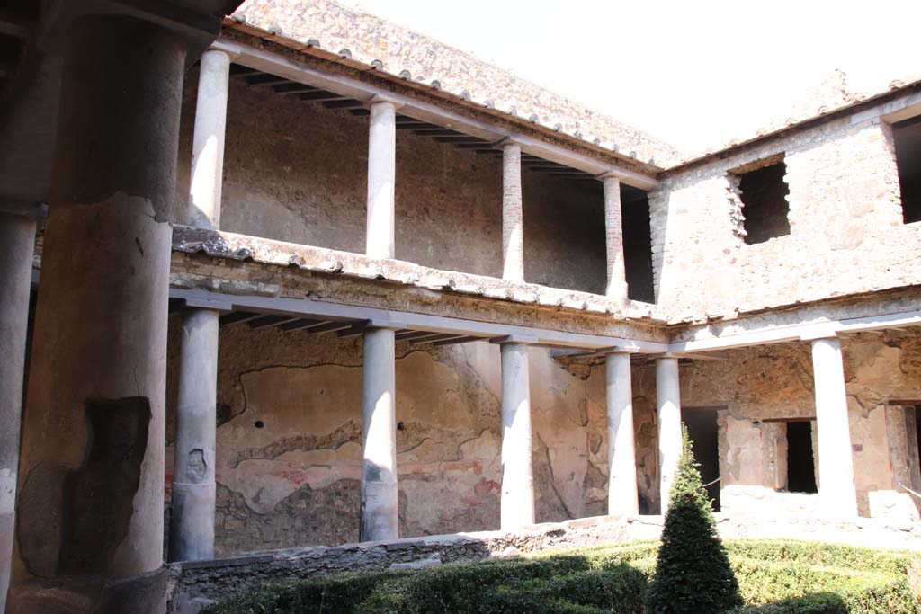 I.10.11 Pompeii. September 2021. 
Room 10, north side of peristyle. Looking north-east to lower and upper floors of peristyle. Photo courtesy of Klaus Heese.
