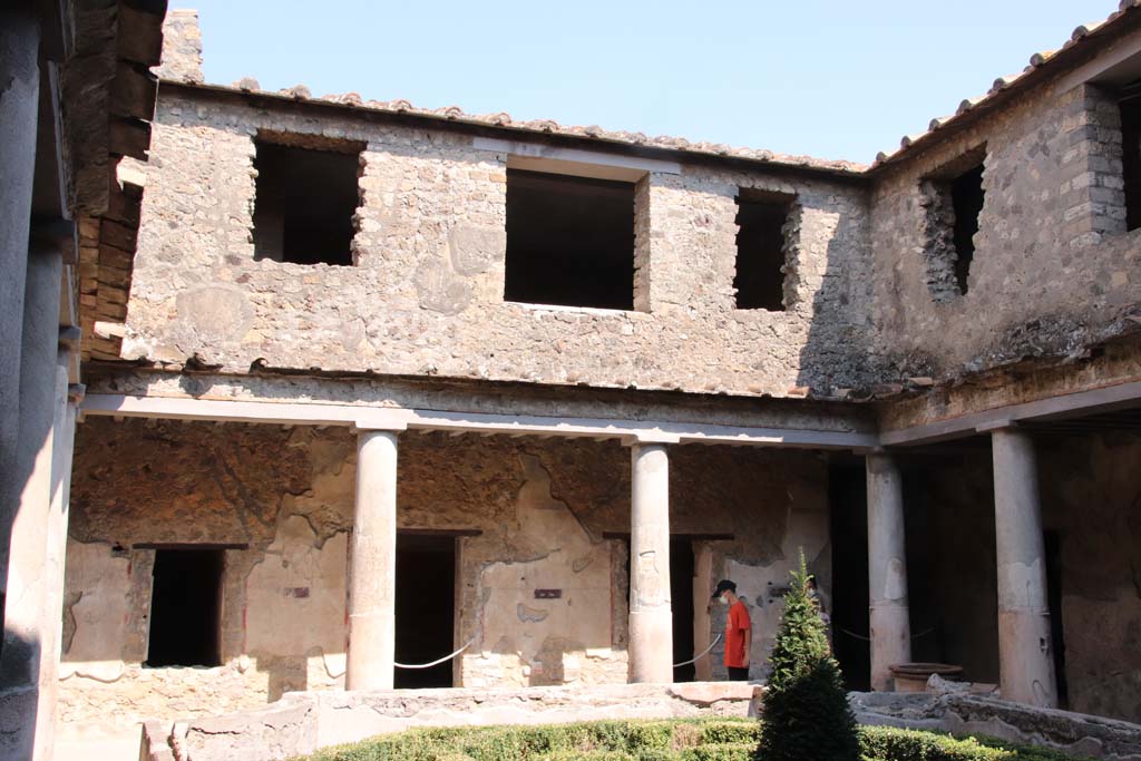 I.10.11 Pompeii. September 2021. 
Room 10, looking towards the east side from the north-west side of the peristyle, with doorway to room 12, in centre. 
Photo courtesy of Klaus Heese.


