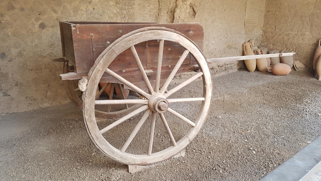 I.10.14 Pompeii. August 2023. Reproduction two-wheeled cart, with bronze and iron fittings. Photo courtesy of Maribel Velasco.