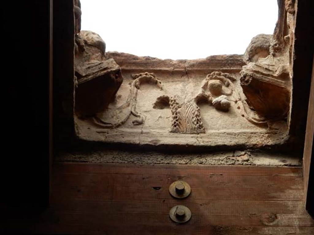 I.10.16 Pompeii. May 2017. Terracotta compluvium above atrium.  Decorated relief on side which has satyr’s head missing. Photo courtesy of Buzz Ferebee.
