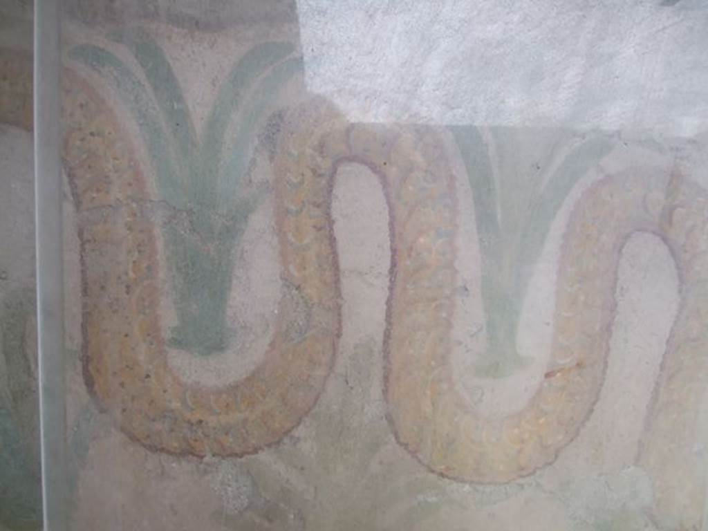 I.11.11 Pompeii.  May 2006. Lararium.  Detail of snake and perennial plants.