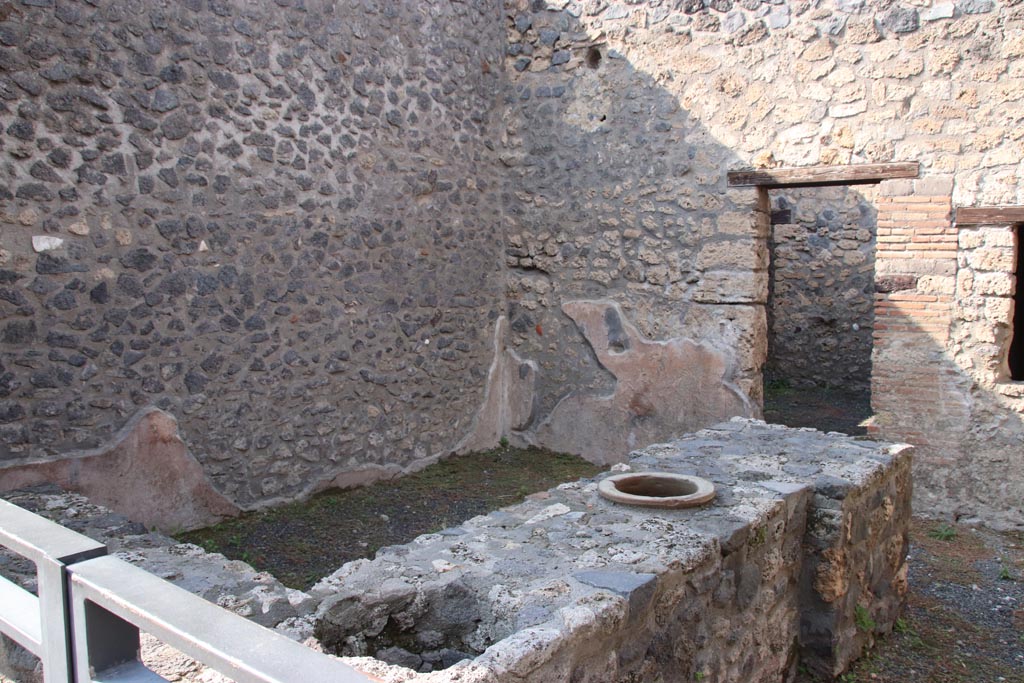 I.11.11 Pompeii. October 2022. Looking north-west across counter towards doorway to rear room. Photo courtesy of Klaus Heese.
