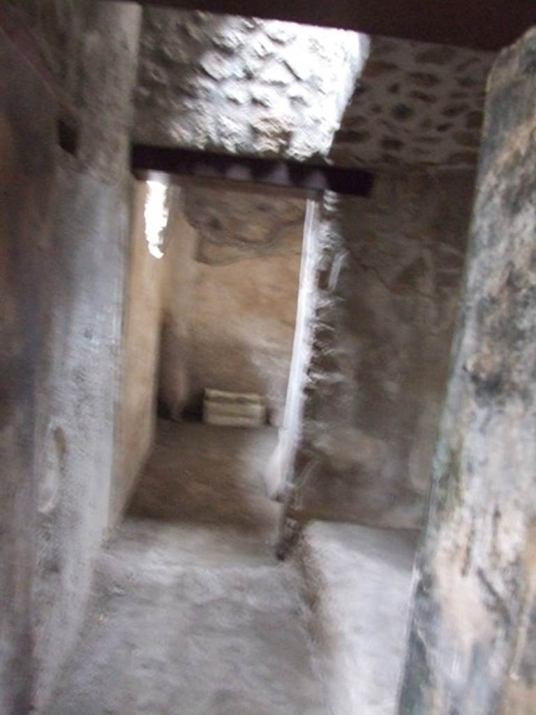 I.11.16 Pompeii. December 2007. Room 7, looking south across the small hallway towards room 7A. According to Packer, both of these rooms would have had walls painted with plain white stucco.
