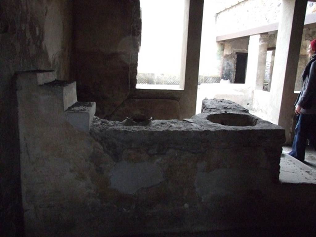 I.11.16 Pompeii. December 2007. Room 3, looking east across caupona with bar.
According to Packer, this would have been the covered atrium. Its east wall would have had two large windows and doorway to the outdoor triclinium in courtyard. Its walls were found with a black dado with a white border separating from a yellow main zone which was partitioned into rectangular panels by narrow red borders. However these paintings may have been a later redecoration applied over an earlier design which included a black main zone, some of which could be seen near to the doorway to room 7. According to Miele, this rectangular covered atrium was without an impluvium.
