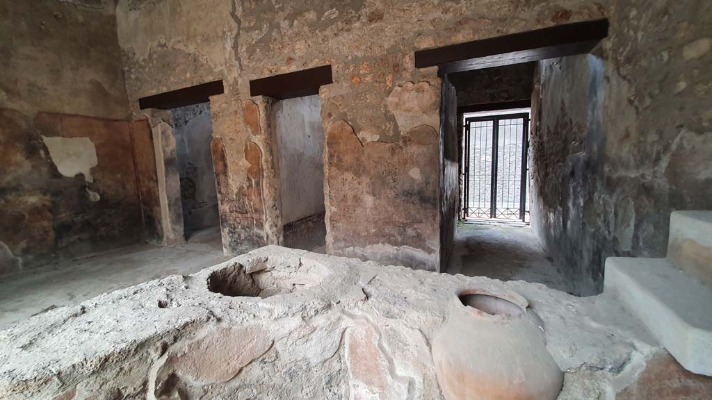 I.11.16 Pompeii. July 2021. 
Looking south-west from bar-counter towards doorways to rooms 5, on left, 4, in centre, and entrance corridor/doorway, on right.
Foto Annette Haug, ERC Grant 681269 DÉCOR.

