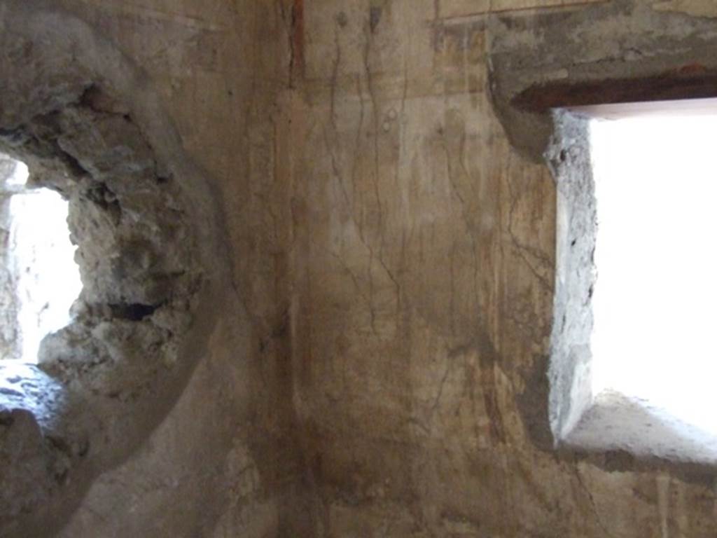 I.12.3 Pompeii. March 2009. Room 2, south-west corner. In the west wall is a window. The round hole in the south wall was made in antiquity.