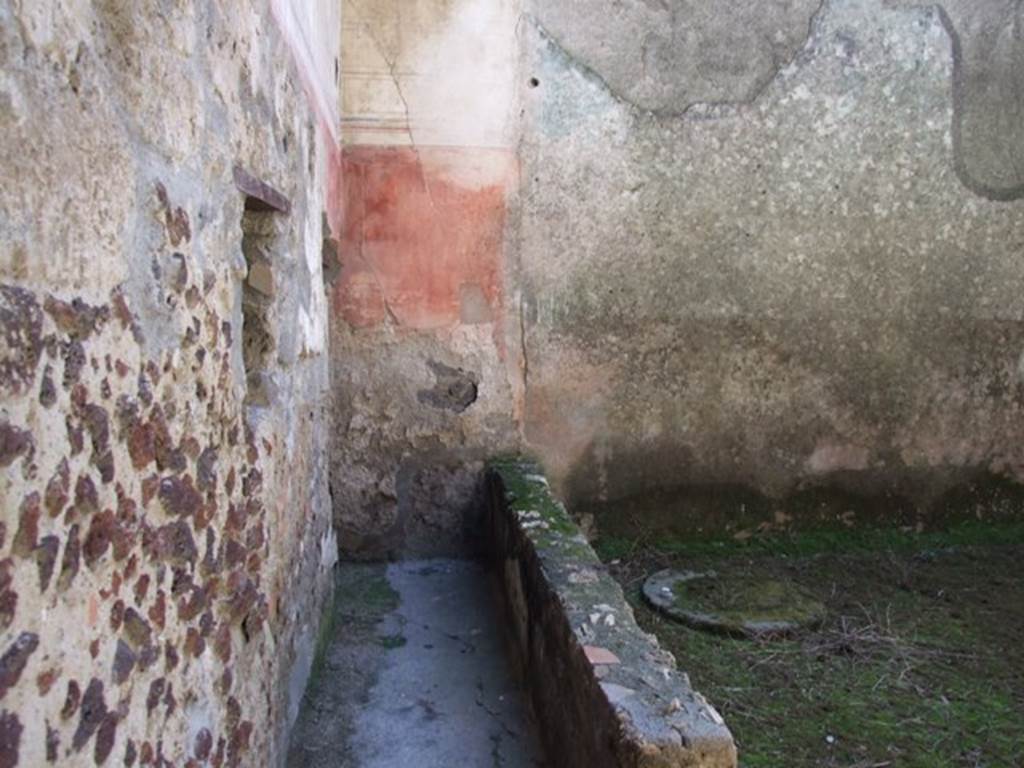 I.12.3 Pompeii. March 2009. Room 6, garden area.
Looking south along passageway on east side of garden area, and cistern in south-east corner.