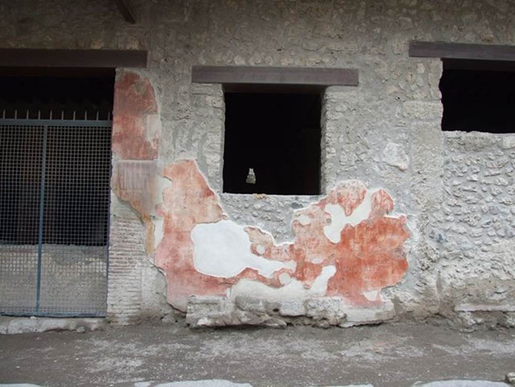 I.12.3 Pompeii. December 2006. Graffiti and plaster on wall to west of door. 
The painted plaster above the graffito on the west (right) of the entrance doorway, used to show a large head of the goddess Minerva.
See Notizie degli Scavi di Antichità, 1914, (p.180-181).
According to Varone and Stefani, to the right of the head of Minerva was a painted graffito, CIL IV, 7430, but no longer visible 
Between the two windows, but now no longer visible, were two painted graffiti, CIL IV, 7438 and CIL IV, 7439.
See Varone, A. and Stefani, G., 2009. Titulorum Pictorum Pompeianorum, Rome: L’erma di Bretschneider. p. 149-153.

Fuscum 
o(ro) v(os) f(aciatis) aed(ilem)     [CIL IV, 7430].

A(ulum) Trebium 
aed(ilem)  
o(ro) v(os) f(aciatis)    [CIL IV, 7438] 

A(ulum) Vettium Firmum aed(ilem) o(ro) v(os) f(aciatis)     [CIL IV, 7439] 

See Epigraphik-Datenbank Clauss/Slaby (www.manfredclauss.de).
