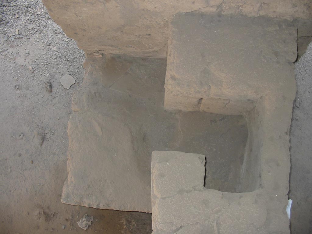 I.12.15 Pompeii. May 2003. Looking down on hearth at south end of counter. Photo courtesy of Nicolas Monteix.