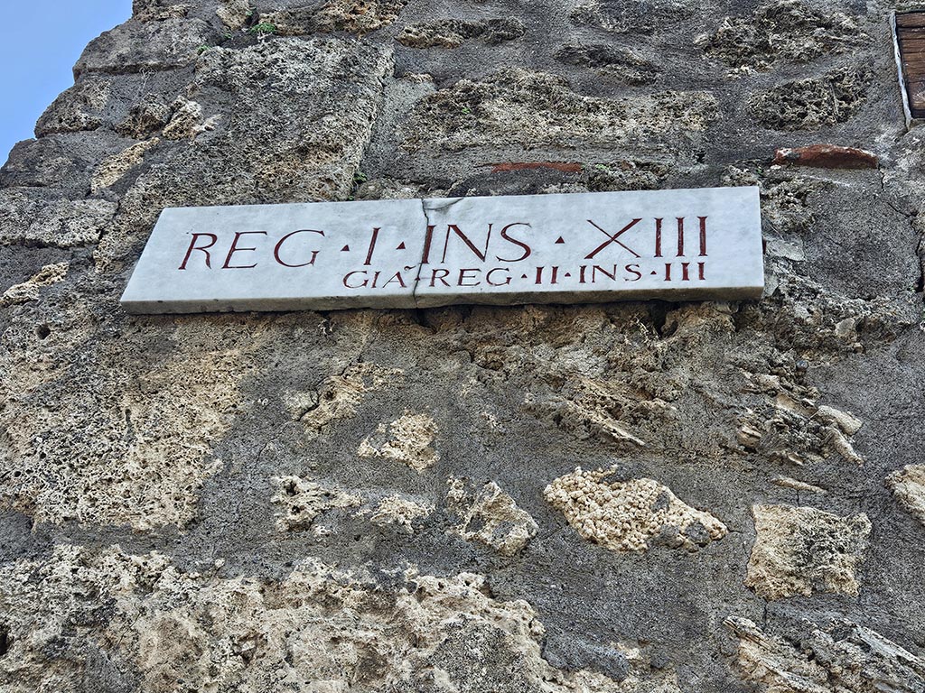 I.13.5 Pompeii. November 2024. 
Insula identification plaque on east side of doorway, originally known as Reg. II, Insula III. Photo courtesy of Annette Haug.
