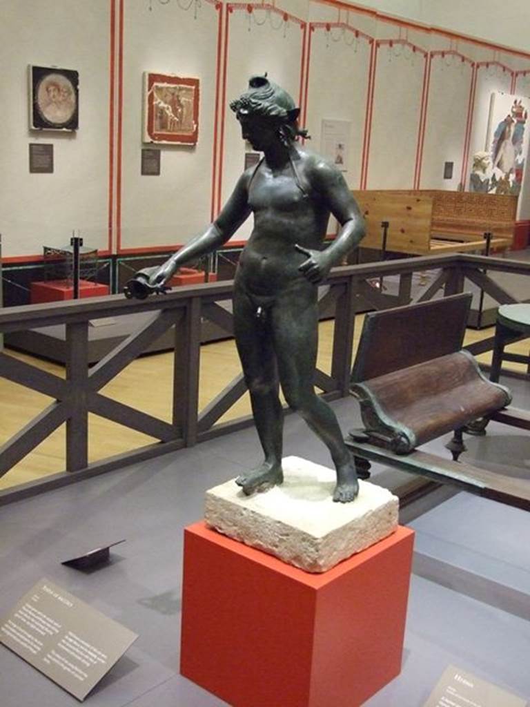 I.16.2 Pompeii.  Found 26th September 1957. Bronze statue of Bacchus. SAP 11864.  Photographed at “A Day in Pompeii” exhibition at Melbourne Museum.  September 2009. This is shown in Rediscovering Pompeii as I.18.2 which is the original numbering, which has since been renumbered to I.16.2. See Conticello, B., Ed, 1990. Rediscovering Pompeii. Rome: L’Erma di Bretschneider.  (p. 267).