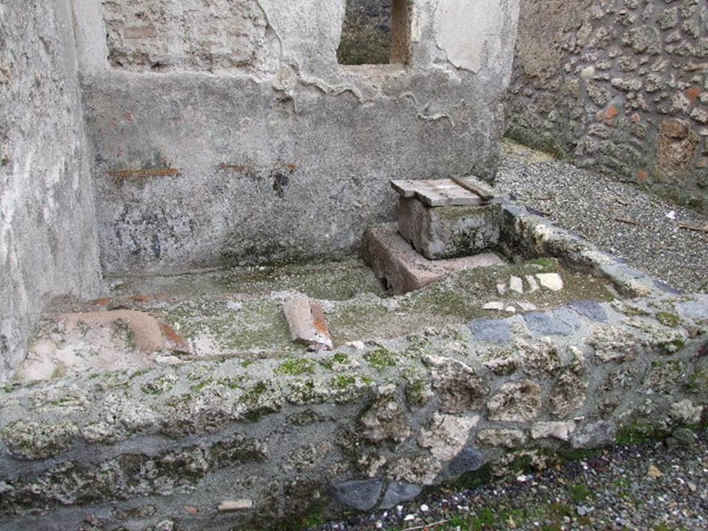 I.16.3 Pompeii. December 2006. Looking south towards rectangular small garden (light-yard?), or pool?  According to Jashemski, the stucco altar and serpent were on a wall above a pool.  There may have been some potted plants on the top of the north side of the low wall that enclosed the small pool built against the light well’s south and east walls.  Such plants would have supplemented the impression of a garden suggested by the garden painting on the wall above the pool.  See Jashemski, W. F., 1993. The Gardens of Pompeii, Volume II: Appendices. New York: Caratzas. (p.64)
