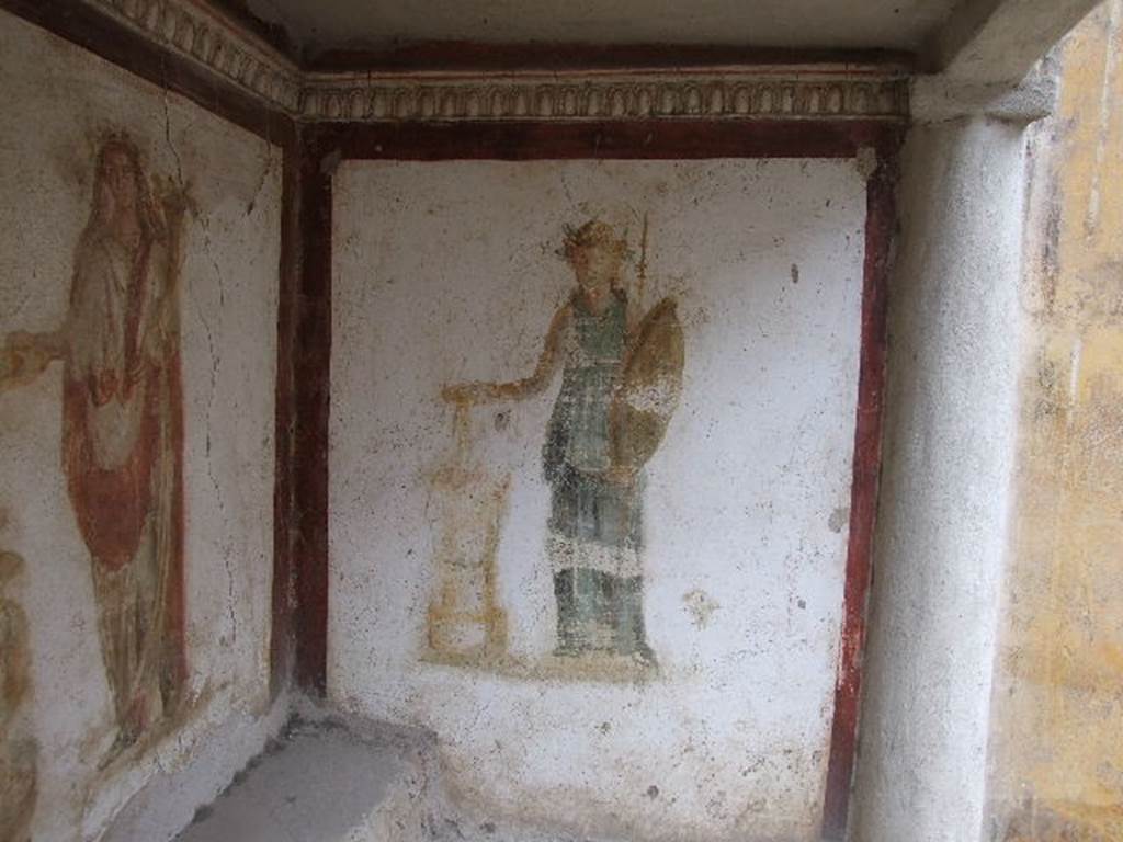 I.16.3 Pompeii. December 2006. North wall in lararium.  Detail of painting of Minerva with sacrifice in a dish in her right hand held over a round altar. See Fröhlich, T., 1991. Lararien und Fassadenbilder in den Vesuvstädten. Mainz: von Zabern, L35 p. 264, taf. 5,3.

