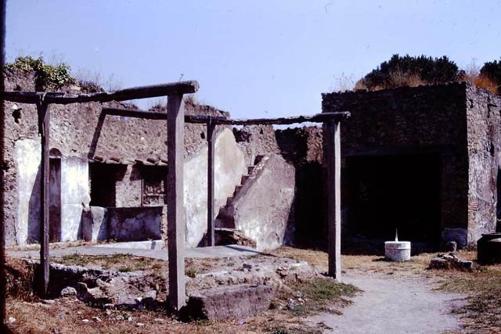 I.20.1 Pompeii. 1974. Looking north-east across triclinium towards steps to upper floor. Photo by Stanley A. Jashemski.
Source: The Wilhelmina and Stanley A. Jashemski archive in the University of Maryland Library, Special Collections (See collection page) and made available under the Creative Commons Attribution-Non Commercial License v.4. See Licence and use details. J74f0713