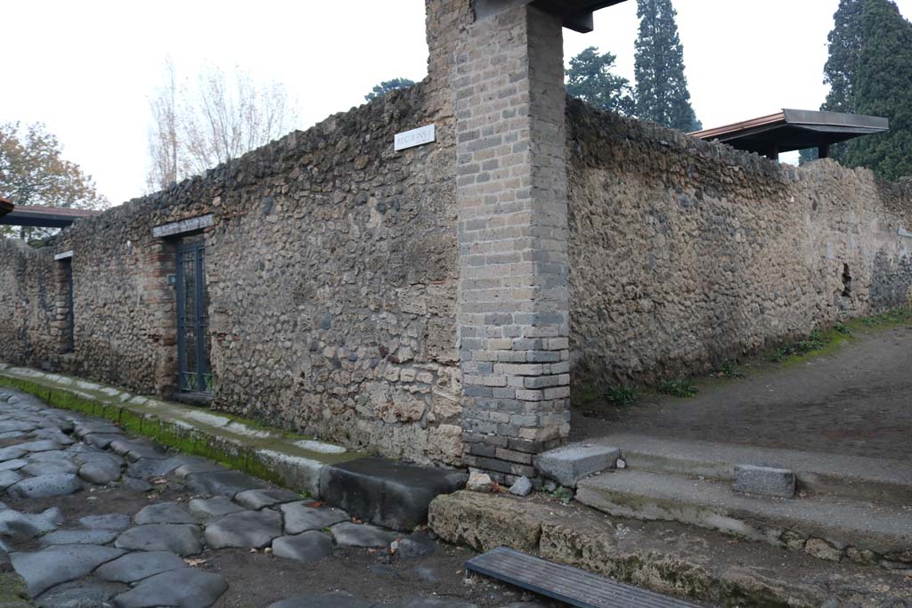 II.1.9, on left, Pompeii. December 2018.
Looking north-east towards entrance doorway on east side of Via di Nocera, at junction with Via di Castricio, on right.
Photo courtesy of Aude Durand.
