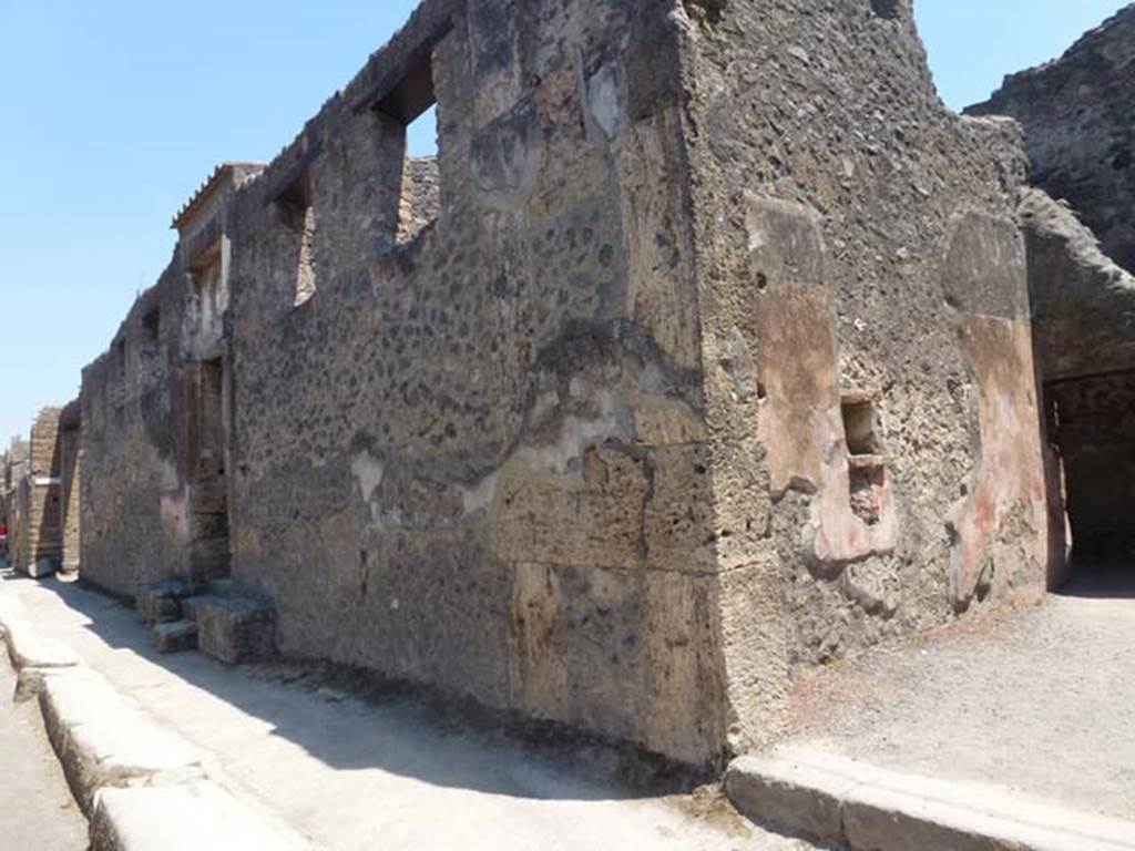 II.2.4 Pompeii. June 2012. Looking east along front façade towards doorway of II.2.4, from II.2.3 (on right). Photo courtesy of Michael Binns.