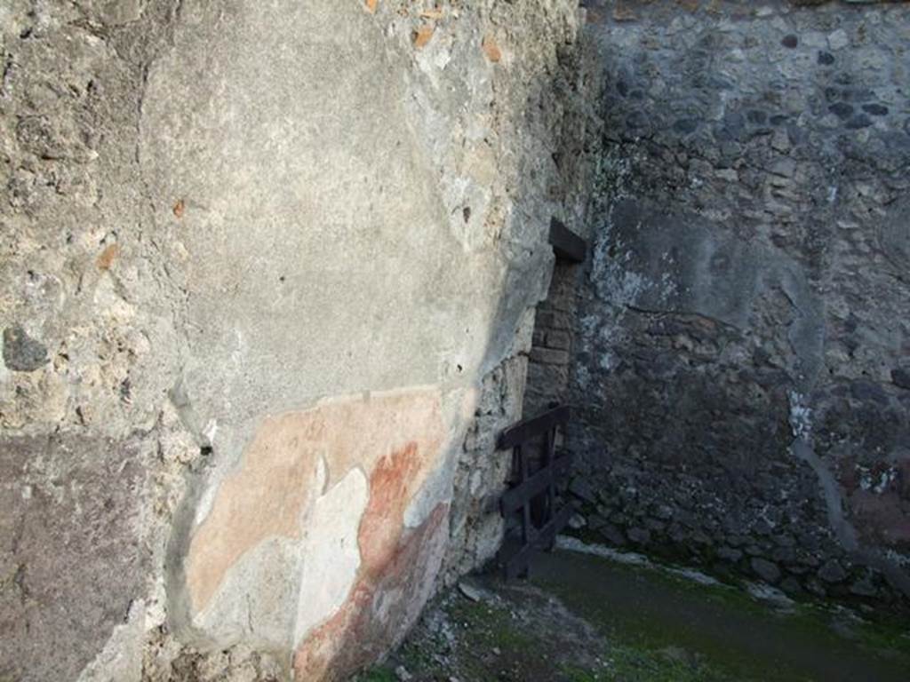 II.3.2 Pompeii. December 2007.  Remains of painted plaster on east wall of workshop.