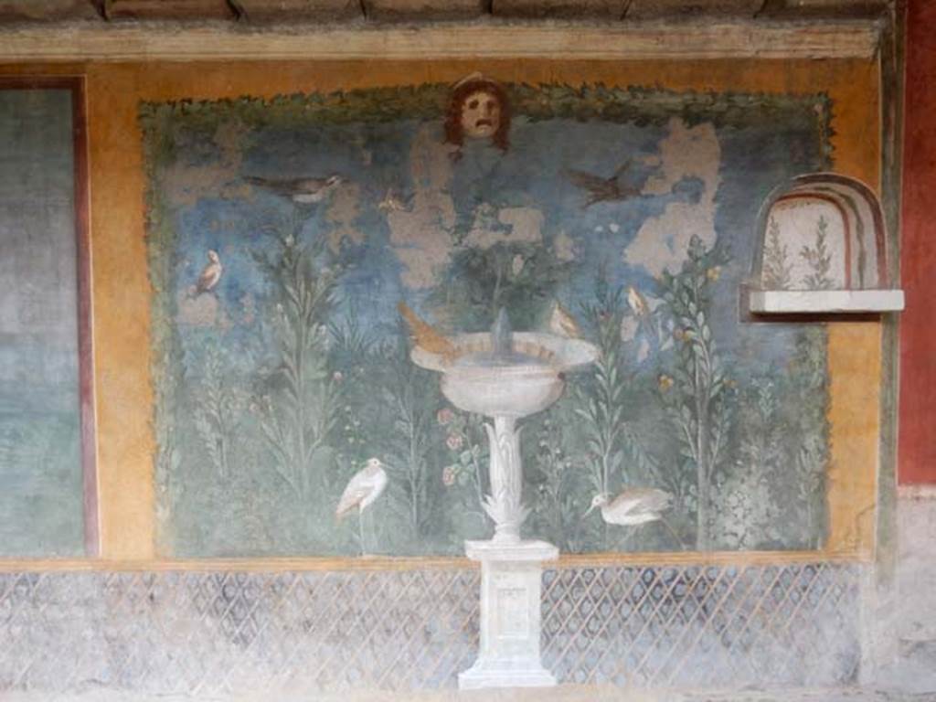 II.3.3 Pompeii. May 2016. Room 11, west panel of south wall of peristyle. 
Wall painting of fountain with garden, mask and birds. Photo courtesy of Buzz Ferebee.

