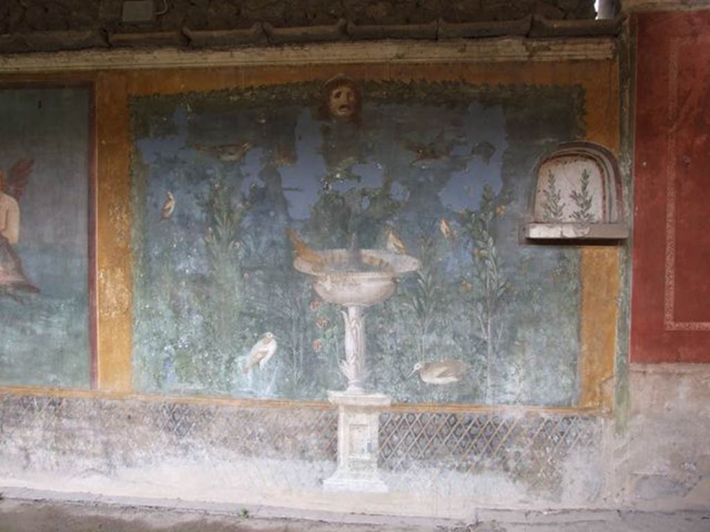 II.3.3 Pompeii. December 2005.Room 11, west panel of south wall of peristyle. Wall painting of fountain with garden, mask and birds.
