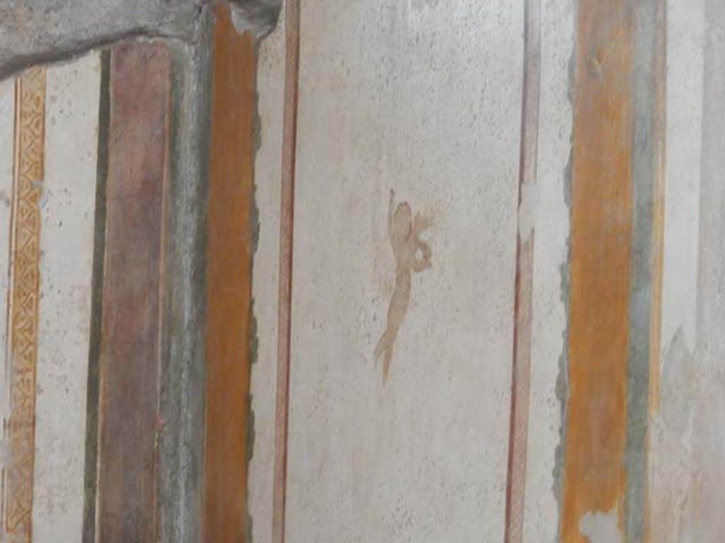 II.3.3 Pompeii. December 2005. Room 4, south wall of cubiculum. 
A flying cherub is on the near panel. The remains of a wall painting of Hermes and Dionysus is in the central wall panel.  
