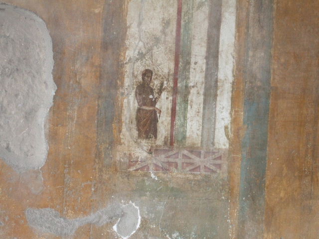 II.3.3 Pompeii.  December 2005.  Room 9, Oecus.  North wall.  Painting of figure in architectural setting.

