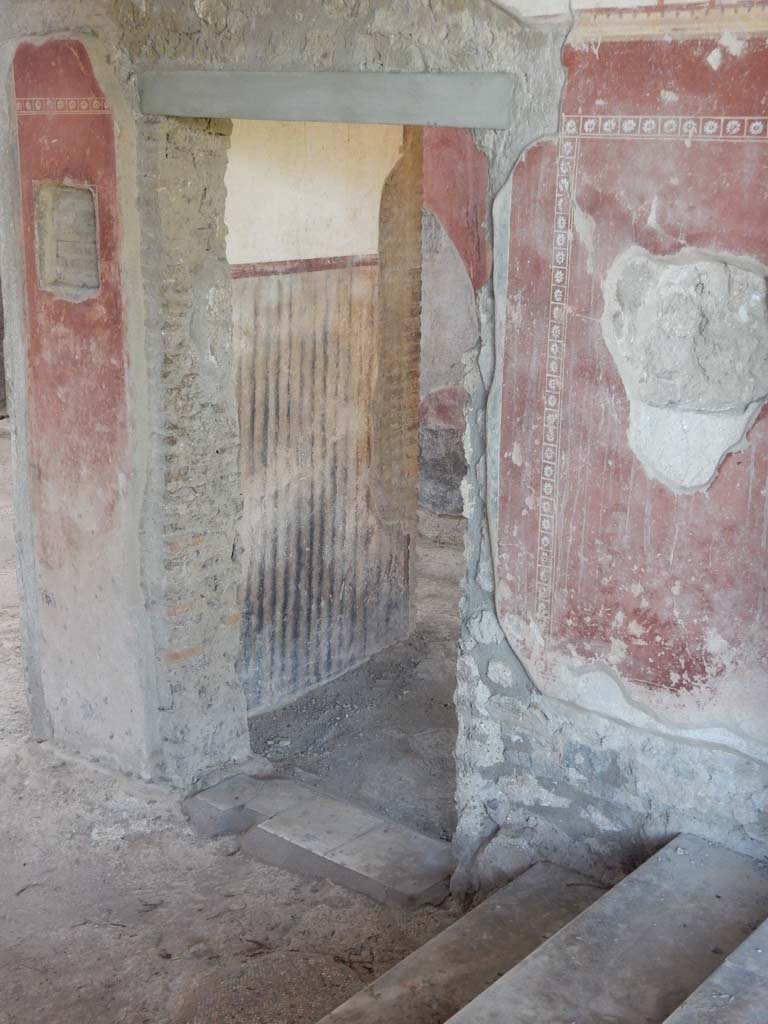 II.4.10 Pompeii. June 2019. Doorway in west wall of atrium, at base of steps from portico. 
Photo courtesy of Buzz Ferebee.
