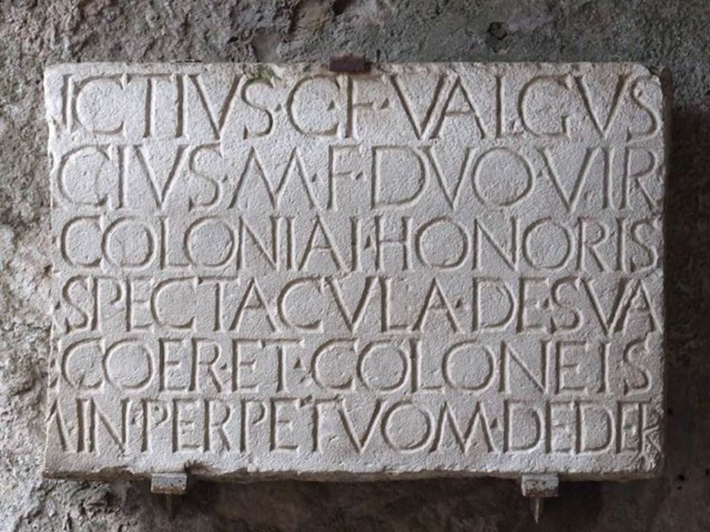 II.6 Pompeii. December 2006. Plaque now fixed to east  wall of exit from the Amphitheatre, leading south-west.  It read -
C. QVINCTIVS C. F. VALGVS
M. PORCIVS M. F[ilius]. DVO VIR.
QVINQ[uennales] COLONIAI HONORIS
CAUSSA SPECTACVLA DE SVA
PEQ[unia] FAC[iunda] COER[arunt] ET COLONEIS
LOCVM IN PERPETVOM DEDER[unt]              [CIL X 852]
Plaque recording:
“Caius Quinctius Valgus, son of Caius, and Marcus Porcius, son of Marcus, in their capacity as quinquennial duumviri, to demonstrate the honour of the colony, erected this sports complex at their own expense and donated it to the colonists for their perpetual use”. 
According to Breton, two of these inscriptions were found (found 13th November 1815) buried in the earth, one near the large south doorway, the other near one of the corridors. See Breton, Ernest. 1870. Pompeia, Guide de visite a Pompei, 3rd ed. Paris, Guerin. 


