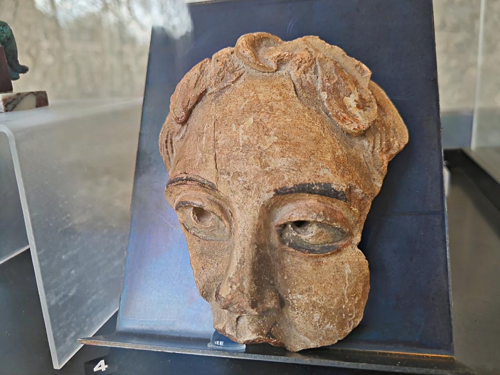 On display in exhibition in Palaestra entitled – “L’altra Pompei, vite comuni all’ombra del Vesuvio”. March 2024.
Detail of No.4 - Terracotta theatre masks (2) Pompeii – provenance not known, but from Pompeii. (Ist century AD).
Photo courtesy of Giuseppe Ciaramella.