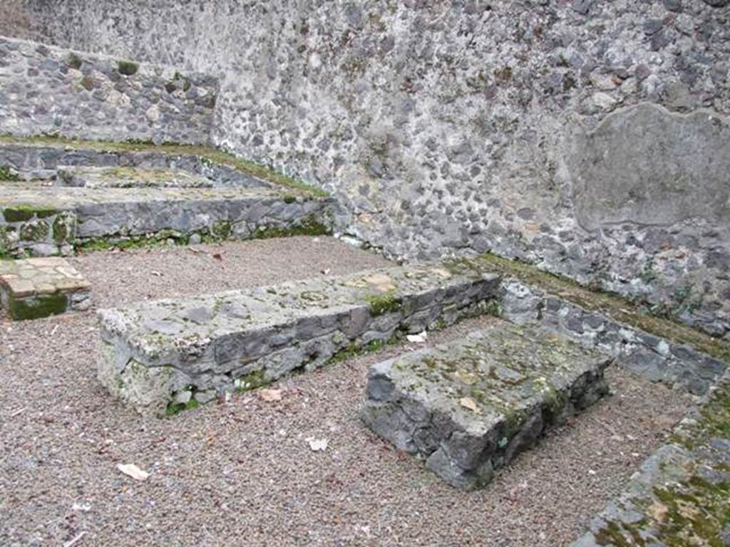 II.8.5 Officina di Sabbatino.  December 2007.  Three sided stone benches and tables built against the south wall, viewed from the west end.