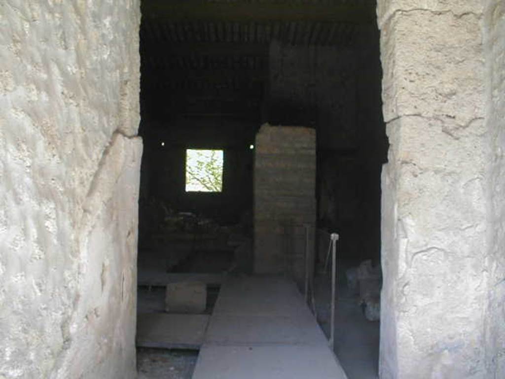 II.9.2 Pompeii. May 2005. Looking east from entrance corridor 1 into room 4. 
In room 4, close to the north wall, two bronze boxes were found containing objects of particular value: gems and work tools, which make the house attributable to a gemmarius or gem cutter.
The stones were yellow jasper, chalcedony-agate, chalcedony-Sardinian, chalcedony-carnelian, chalcedony-carnelian, chalcedony-carnelian, chalcedony-carnelian, chalcedony blue, prasio, quartz stone, rock crystal, and there were three chisels.
See Attivit della Soprintendenza: Regio II, Insula 9: Rivista di Studi Pompeiani II, 1988, p. 200, p. 202 note 12.

