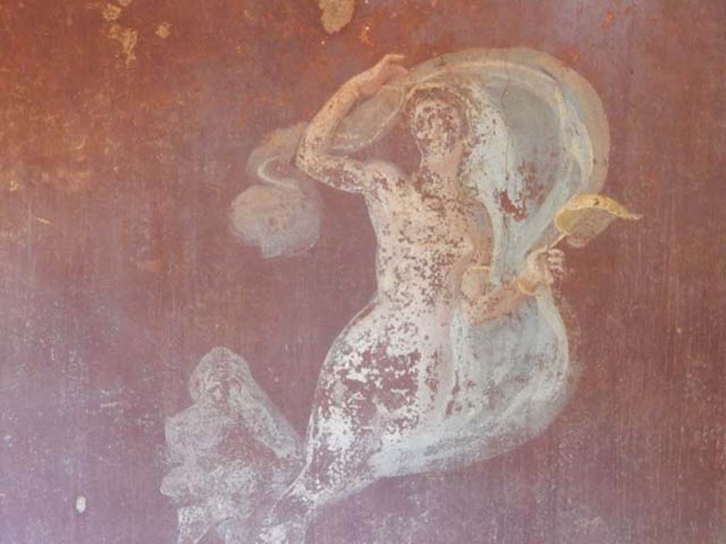 II.9.4, Pompeii. May 2018. Room 6, detail of painted figure on red panel on west wall. Photo courtesy of Buzz Ferebee. 