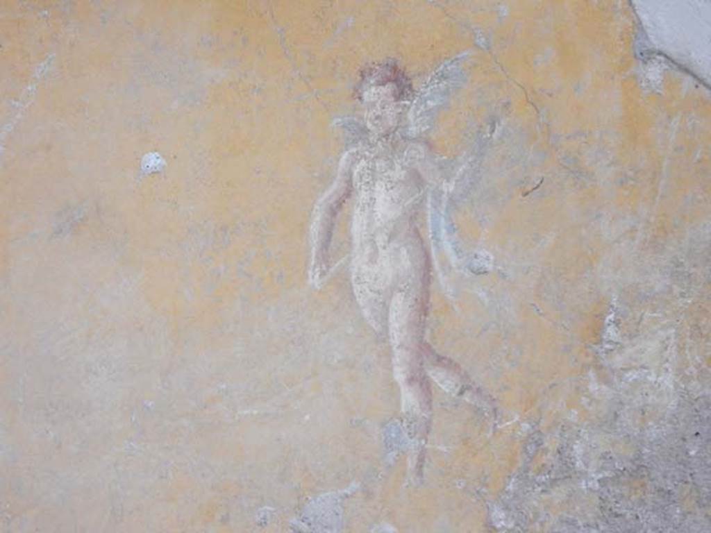 II.9.4, Pompeii. May 2018. Room 8, north wall, painted figure from centre of panel on east side of doorway.
Photo courtesy of Buzz Ferebee. 
