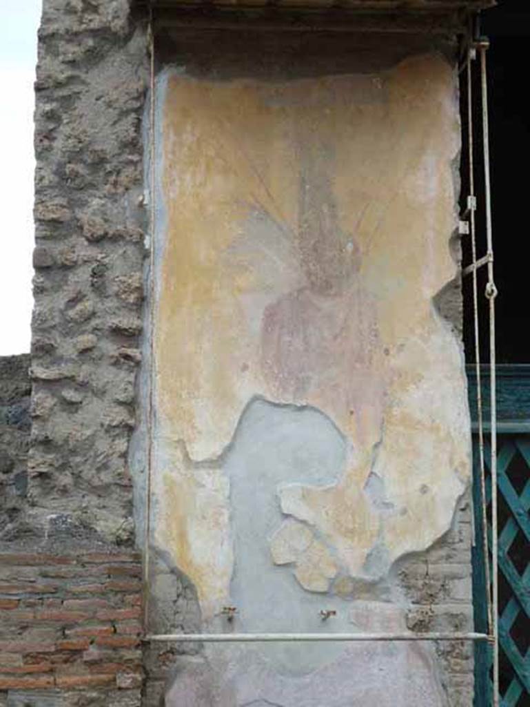 III.3.6 Pompeii. May 2010. Painted Roman trophy figure on west entrance pilaster. 