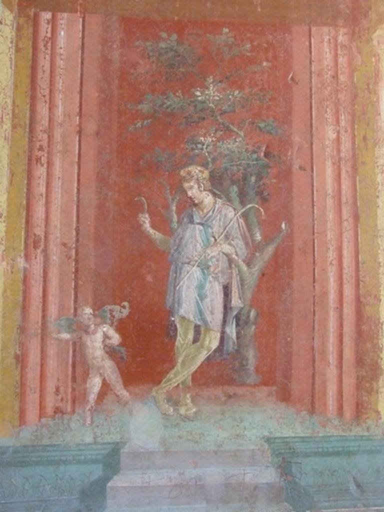 III.4.b. Pompeii.  March 2009. Room 3.  Oecus.  East wall.  Detail of wall painting of Attis, with a winged cupid pointing to Sangaritide