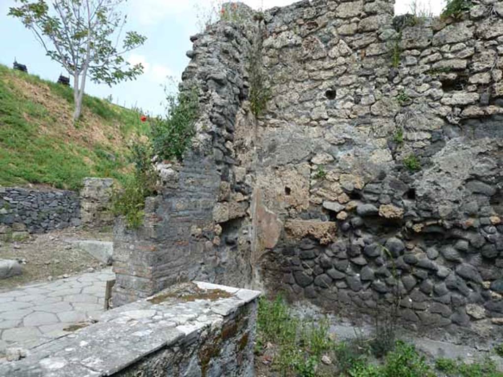 III.8.8 Pompeii. May 2010. North-east corner of bar room. On 1st April 1903, whilst clearing the earth away up to a meter from the old ground level, two human skeletons were found.
With them were large terracotta amphora fragments, and a slab of white marble (0.70 x 0.46m). See Notizie degli Scavi di Antichità, 1905, (p.275). According to Luongo et al, the two skeletons were found in the north-east corner. They numbered Astylus’s thermopolium as being at Reg. III, Insula 9.  See G. Luongo et al: Impact of the AD79 explosive eruption on Pompeii, in Journal of Volcanology & Geothermal Research 126 (2003) (p.185).