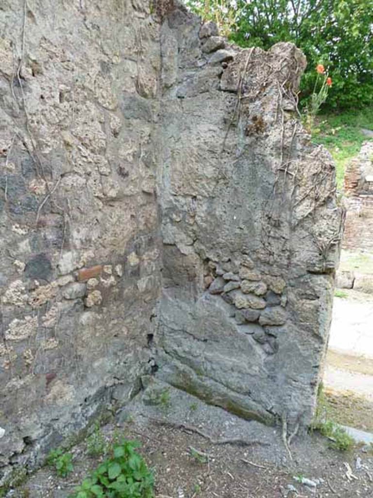 III.8.8 Pompeii. May 2010. North-west corner of bar room.
According to the Giorn. dei Soprastanti, near the right entrance pillar of the bar room at the height of about a metre from the ground, a human skeleton was found in the lapilli. 
Found leaning against him was a large broken amphora in many pieces.
Found between the podium and the amphora was a large grey slab of marble.
See Notizie degli Scavi di Antichità, 1905, (p.275)
