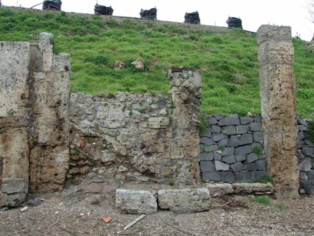 IV.2.b Pompeii. March 2009. Entrance doorway, with remains of a bench on the west side of it. According to Sogliano, this doorway noted for its square blocks of Sarno stones led to an entrance corridor flanked by two cubicula. The one on the right was decorated with beautiful stucco. Found there on 27th December 1902 were the remains of a human skeleton. Found on 29th December 1902 was a terracotta lamp decorated with a tragic mask. See Notizie degli Scavi di Antichità, 1905, (p.280). According to CTP, it was definitely the house at b with the two cubicula near its entrance that was mentioned by Sogliano. See Van der Poel, H. B., 1986. Corpus Topographicum Pompeianum, Part IIIA. Austin: University of Texas. (p.68). According to Luongo et al, the skeleton was found to the right of the entrance in House d. See G. Luongo et al: Impact of the AD79 explosive eruption on Pompeii, in Journal of Volcanology & Geothermal Research 126 (2003) (p.185).