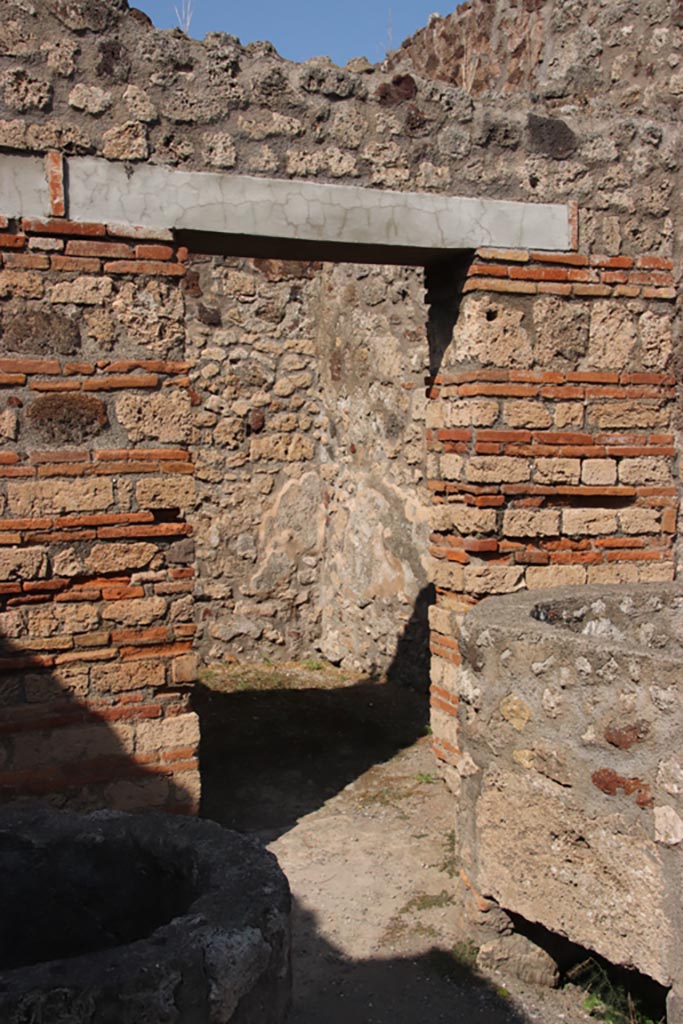 V.1.4 Pompeii. October 2023.
Looking towards doorway to rear room in north-east corner of entrance room. Photo courtesy of Klaus Heese.