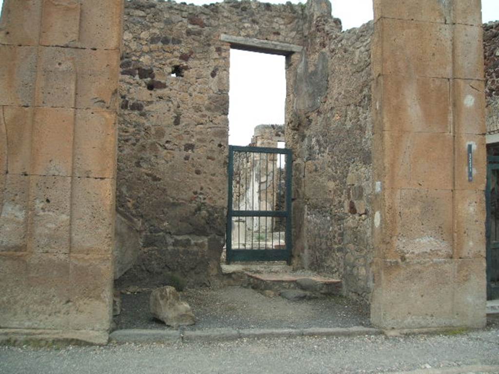 V.1.6 Pompeii. May 2005. Looking north across shop from Via di Nola, towards doorway in north wall to atrium of V.1.7.