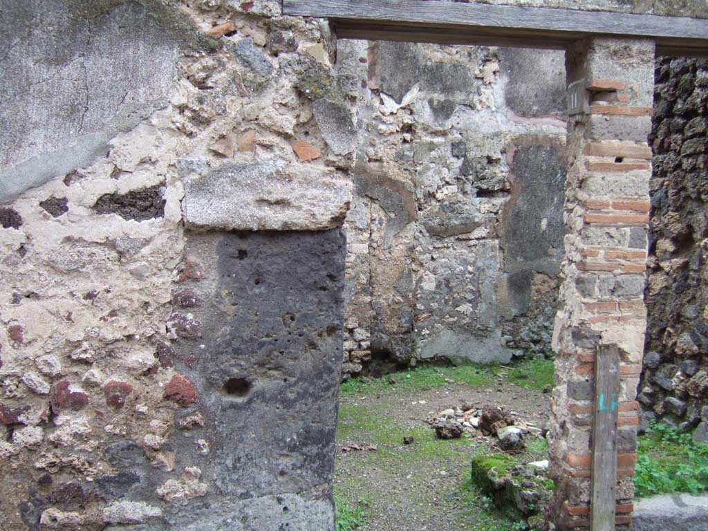 V.1.11 Pompeii. October 2023. 
Looking south-east from entrance doorway towards latrine with low doorway, then kitchen doorway, followed by corridor leading into V.1.18.
Photo courtesy of Klaus Heese.
