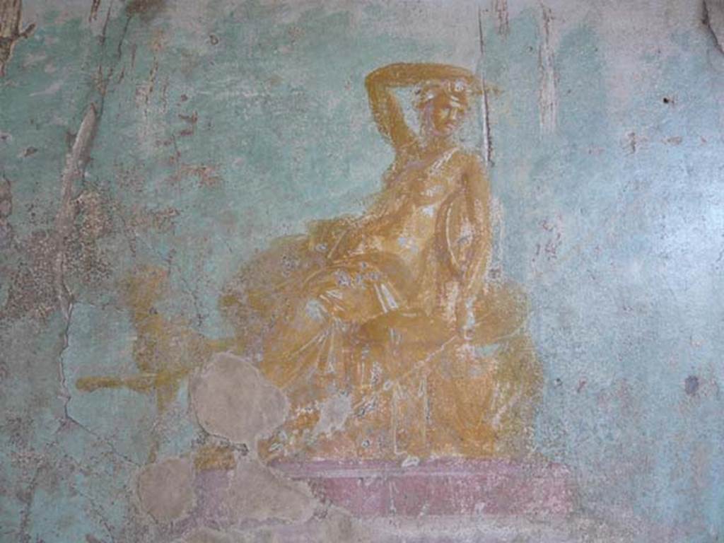 V.1.18 Pompeii. May 2012. Painting of golden seated figure in centre of east wall of exedra “y”, described as both Dionysus, or perhaps Arianna. Photo courtesy of Buzz Ferebee. 
